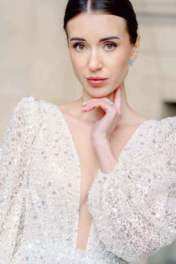 Paris pre-wedding session at the Louvre with bride in a sequined gown with a full train, long sleeved, deep plunging neckline and back, photographed by Italy destination photographer